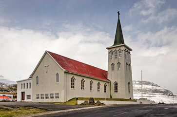 Fototapeta na wymiar Grundarfjörður, Iceland, May 6, 2022: the town's church on a cloudy day