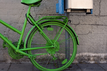 green painted bicycle in the city
