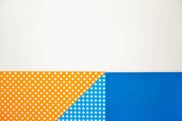 The paper is blue and orange. Various geometric shapes. White circles. Abstract background and texture.