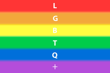 lgbtq text on blurry rainbow flag