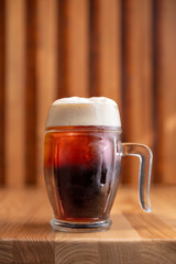 Glass of fresh beer on a wooden table. Top view copy space