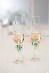 wedding glasses with champagne wine on the table decorated with flowers