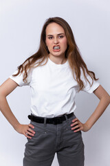 girl with brown hair in a white T-shirt and gray jeans