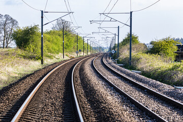 Fototapeta na wymiar East Coast of England railway line with tracks curving, overhead line equipment and railway signs