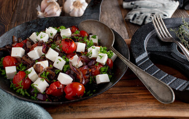 Fitness recipe with a warm mediterranen salad. Marinated with olive oil and topped with real feta cheese and parsley