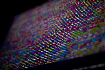 Colorful code background. compressed javascript code on computer screen. Software developer coding screen