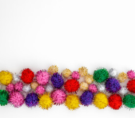 sparkle tinsel pom poms on a white background