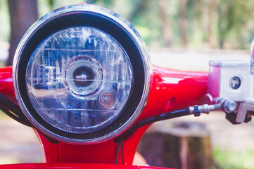 close -up view of the red scooter headlights