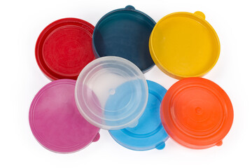 Colored plastic lids for glass jars on a white background
