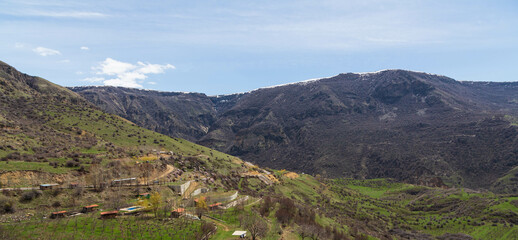 Armenian landscape with rooftops of Garni village, located in the mountains. Garni, Armenia