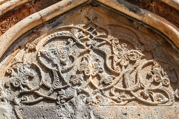 Close-up entrance portal to the church and monastery of Geghard in Armenia with ornamental carvings. Geghard monastery, Armenia