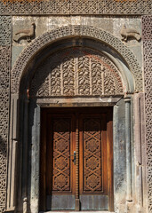 Close-up entrance portal to the church and monastery of Geghard in Armenia with ornamental carvings. Geghard monastery, Armenia
