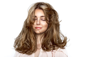 Portrait of a beautiful natural girl with beautiful healthy hair on a white background. A beautiful young girl with a perfect face and beautiful flowing hair. Beauty hair - concept.