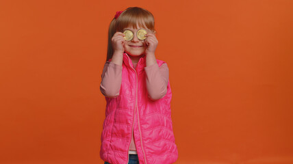 Happy girl winner showing golden bitcoins. Career wealth, cryptocurrency investment, mining future technology. Young little child fooling making faces. Happy businessman isolated on orange background