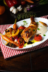 Rustic fried chicken legs with assorted vegetables and rice