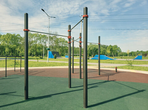 Sports field in a public park, horizontal bar and bars for outdoor gymnastics, sports activity for health