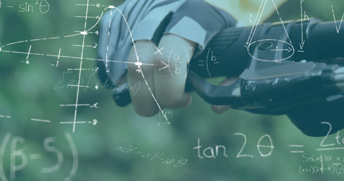 Mathematical equations and diagrams against person holding handlebars of his cycle - Powered by Adobe
