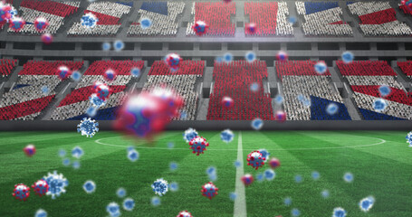 Image of covid 19 cells over british flag in empty sports stadium