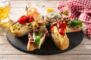 Assortment of Spanish pintxos on wooden table