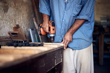 Man assembling furniture and fixing it - hobby concept.