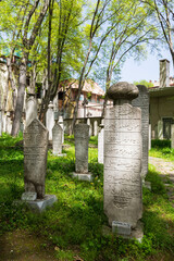 Istanbul, Turkey - April, 2022: The dervish tombstones in the cemetery of Galata Mevlevihane Museum (Silent House) in Istanbul