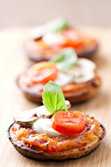 Mini Pizza Margherita with fresh Tomato, Mozzarella, Mushrooms and Basil.