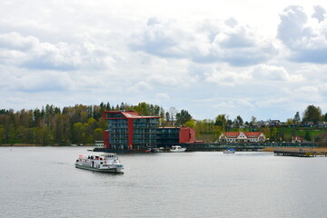 A view of a luxirious boat parked next to a small wooden marina, pier or platform with a metal...