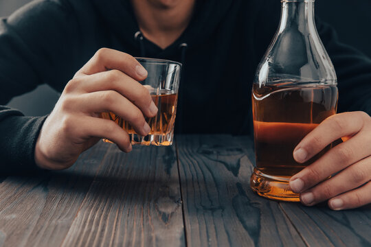 Men Holding A Glass Of Whiskey