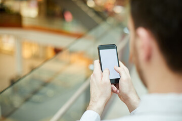 Close-up of unrecognizable businessman texting sms on gadget or searching for information on internet