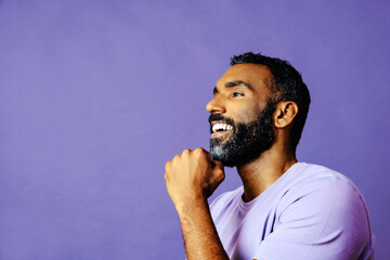 profile headshot of a handsome smiling african american man with beard and mustache purple shirt...