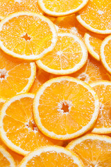 Vertical image of fresh sweet orange slices. Orange background.