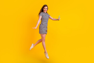 Fototapeta na wymiar Full length profile side photo of young girl jump make selfie cellphone trip isolated over yellow color background