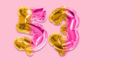 Rainbow foil balloon number, digit fifty three on a pink background. Birthday greeting card with inscription 53. Top view. Numerical digit. Celebration event, template. Banner