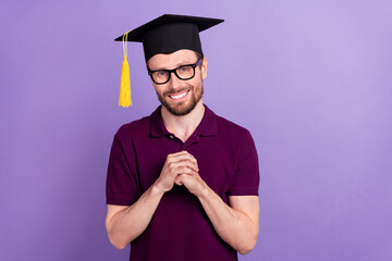 Photo of young handsome man wear mortarboard degree graduate bachelor isolated over violet color background