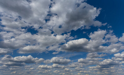 dramatic dense cumulus clouds on blue sky natural background