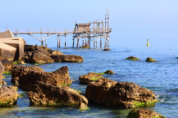 Fototapeta na wymiar Coast of the Trabocchi, Trabocco in Marina di San Vito Chietino. The Trabocco is a traditional wooden fishing house on pilework typical of Adriatic sea, coast of Abruzzo, Italy