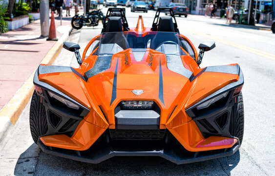 Miami Beach, Florida USA - April 14, 2021: orange polaris slingshot, front view.