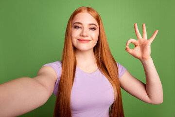 Photo of young attractive woman show finger okey symbol approve quality great isolated over green color background