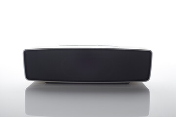 Horizontal sound speaker with reflection isolated on white background.