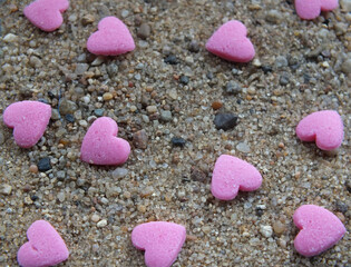 Fototapeta na wymiar PInk Hearts on Sand
