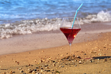 Wine glass with a cocktail by the sea.