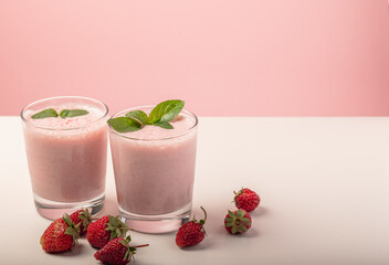 Fresh strawberry milkshake garnished with mint leaves.Cool summer drink. Selective focus.