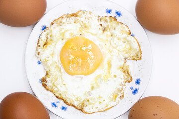 whole eggs and fried egg isolated on white background on top view. Food cooking photo object design