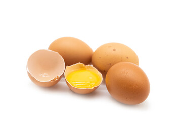 whole eggs and one broken isolated on a white background