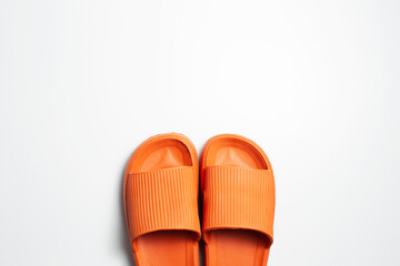 Close-up of orange slippers isolated on white background. Summer concept.