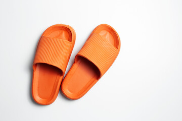 Top view of colourful slippers of orange color, isolated on white background. - obrazy, fototapety, plakaty