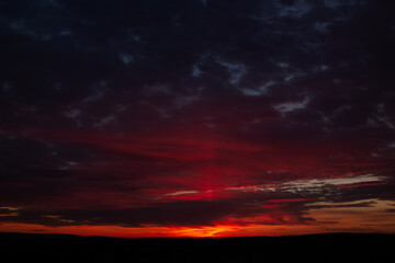 Fototapeta na wymiar Dramatic landscape of beautiful sunset with dark clouds.