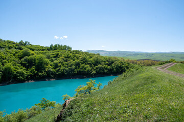 Blue karst lake in the mountains in summer