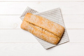 Fresh ciabatta bread on napkin on rustic background, Italian bread top view