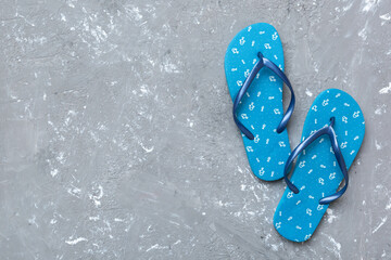 Flat lay composition with flip flops and seashell on colored background. Space for text top view